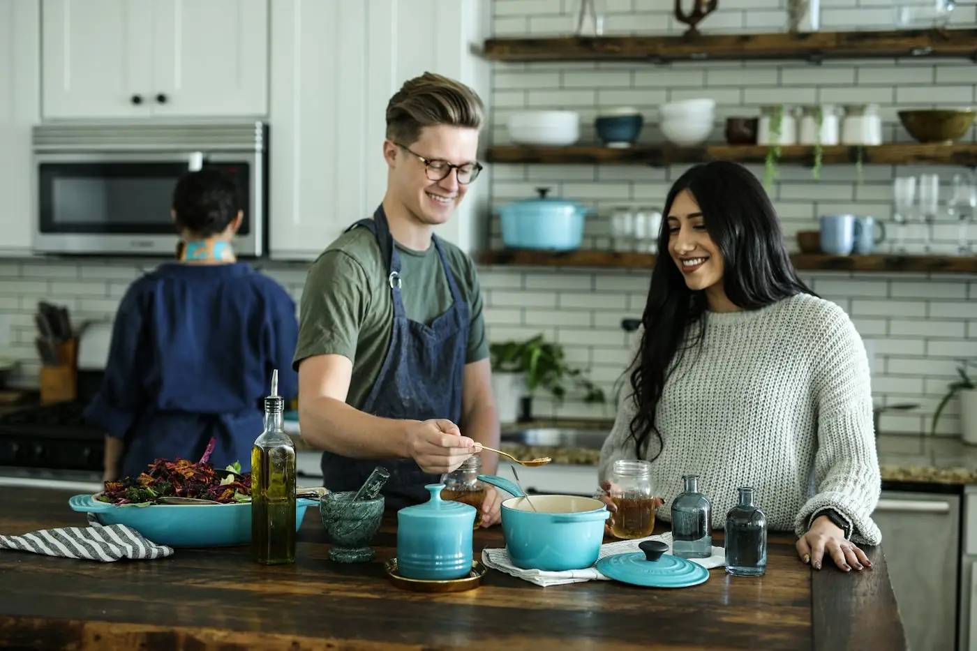 People cooking a meal together in a home kitchen
